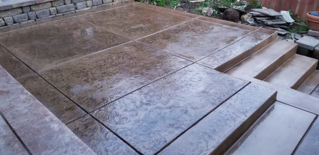 New textured brown concrete residential patio deck 