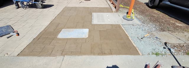 public concrete sidewalk with underground sewer connection