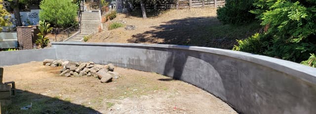 new residential concrete foundation in a backyard of a home