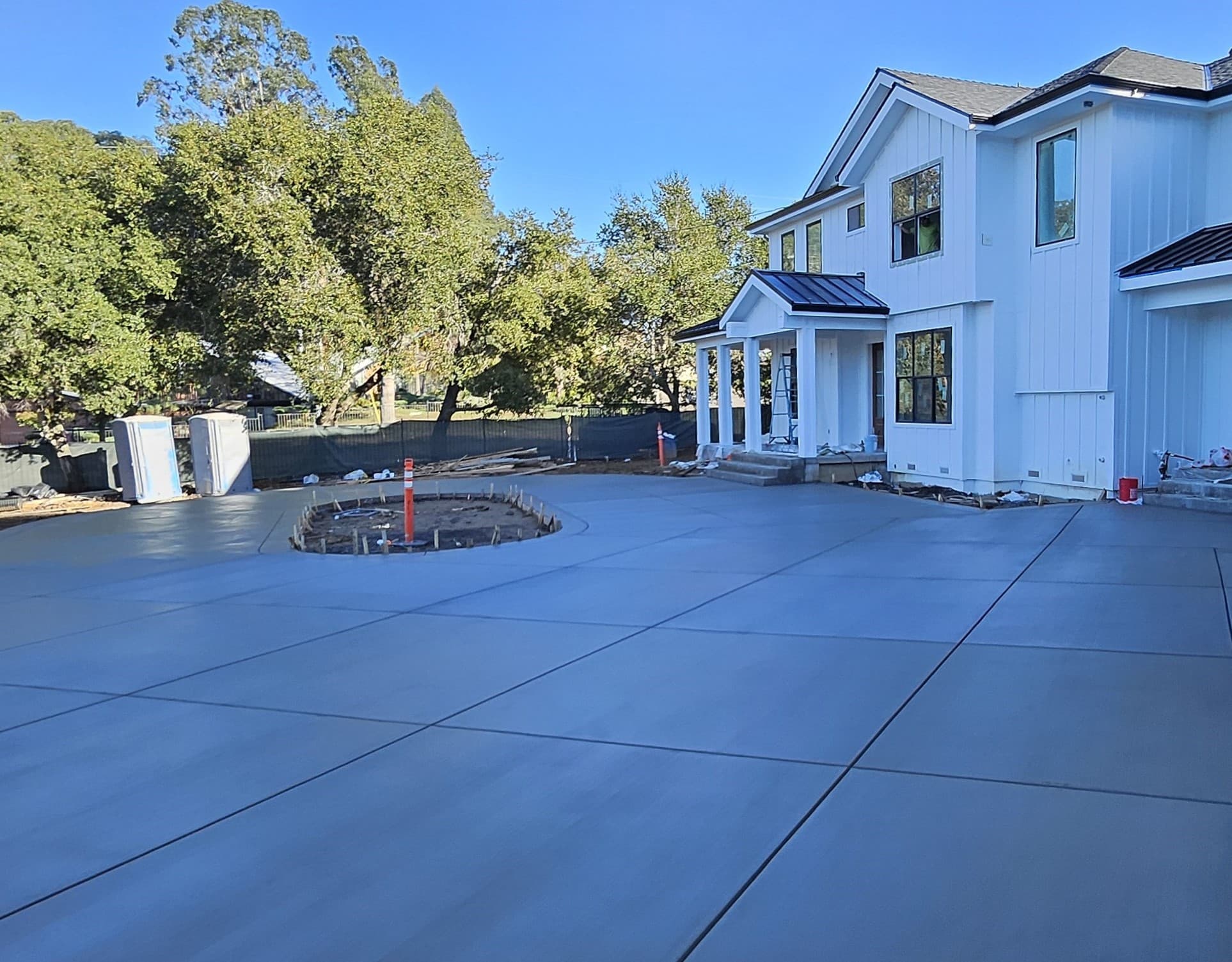 Brand new Concrete driveway in front of a home and garage 